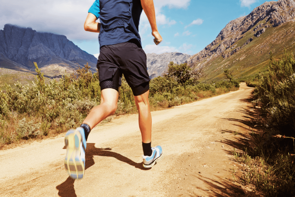 man trail running in the mountains