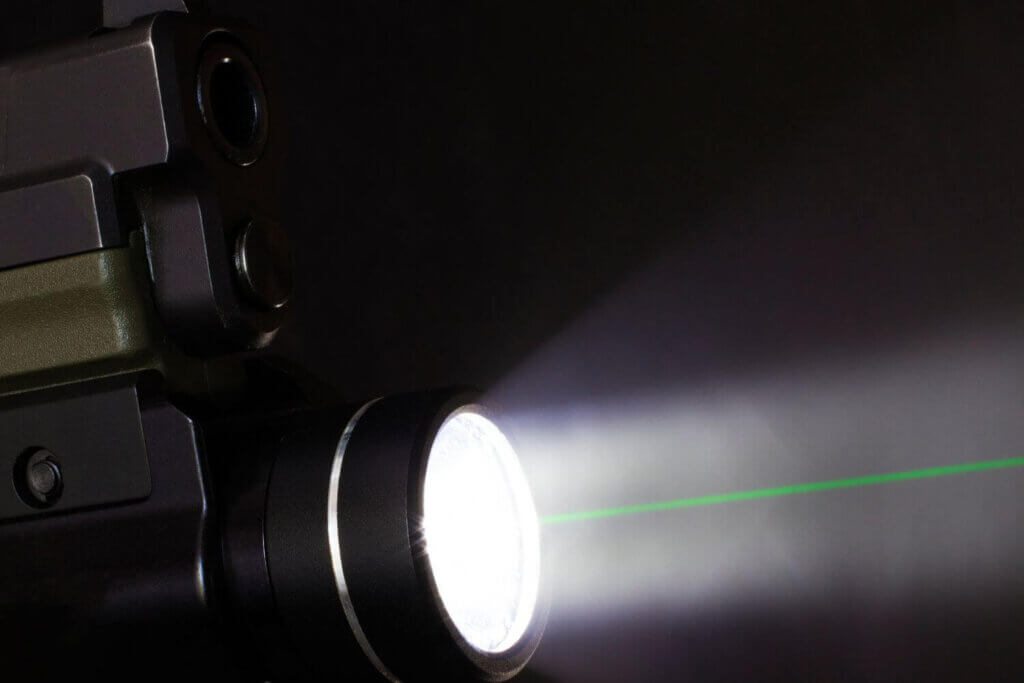 Handgun mounted light with green laser for precise target shooting