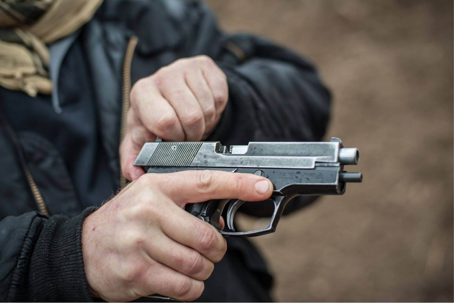 Close up view of a pistol - man doing clearance drills