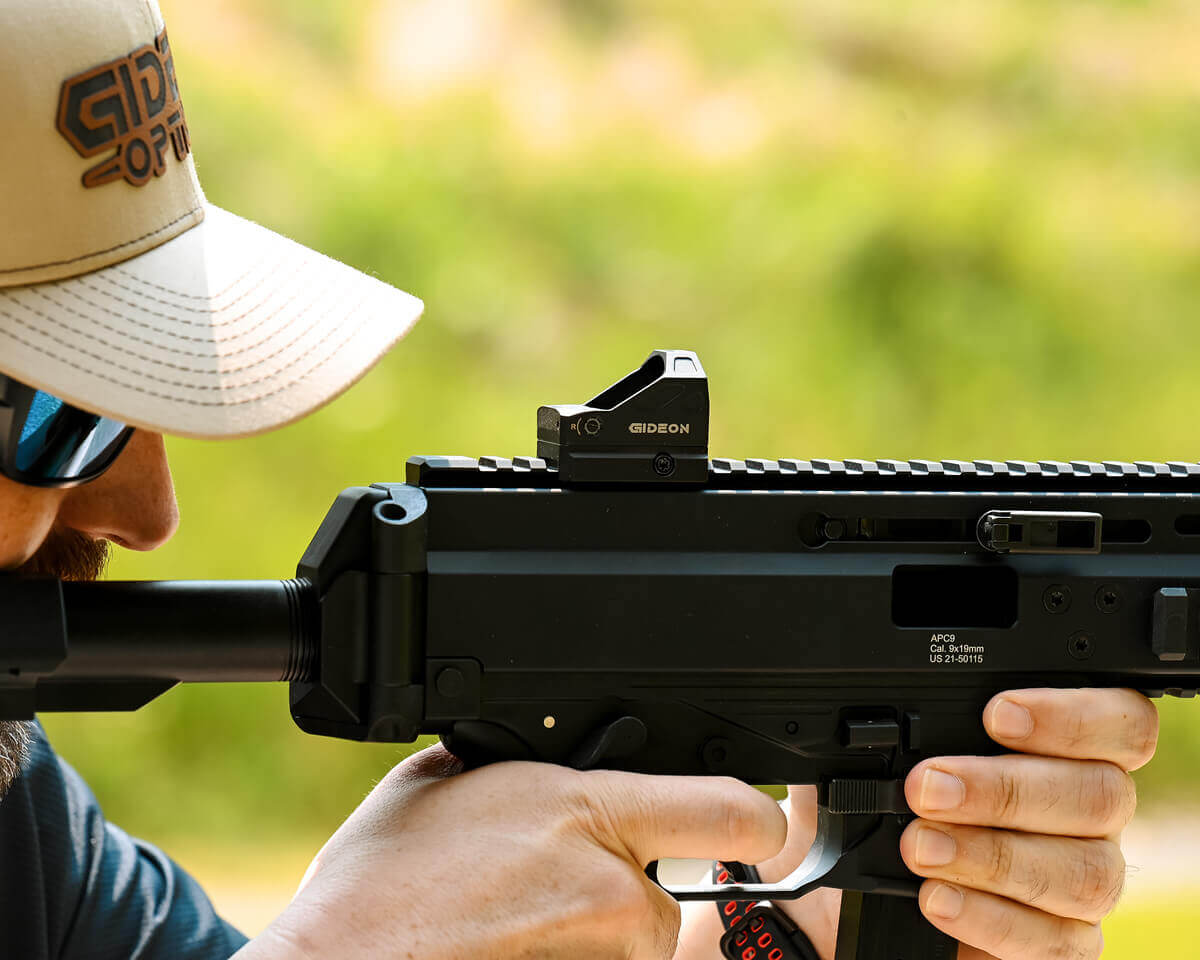 man firing the trigger of an APC9 at the shooting range