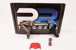 PR Triggers Model G trigger components placed in front of PR Triggers packaging