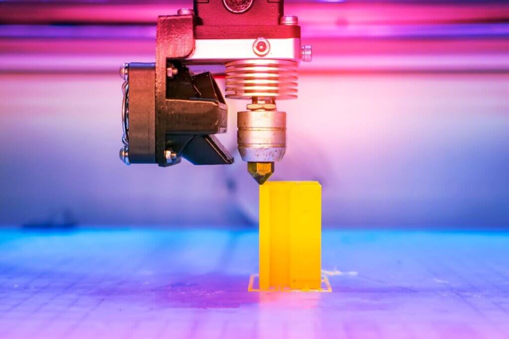 Modern 3d Printer creating a yellow product
