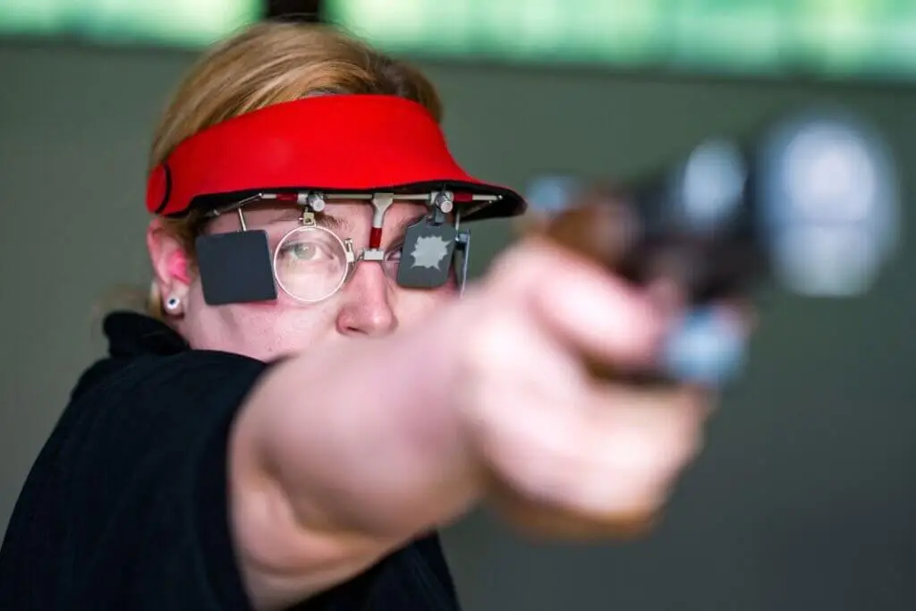 Woman in a pistol sport shooting competition - Premier Gun Parts And Accessories | JSD Supply Woman in a pistol sport shooting competition
