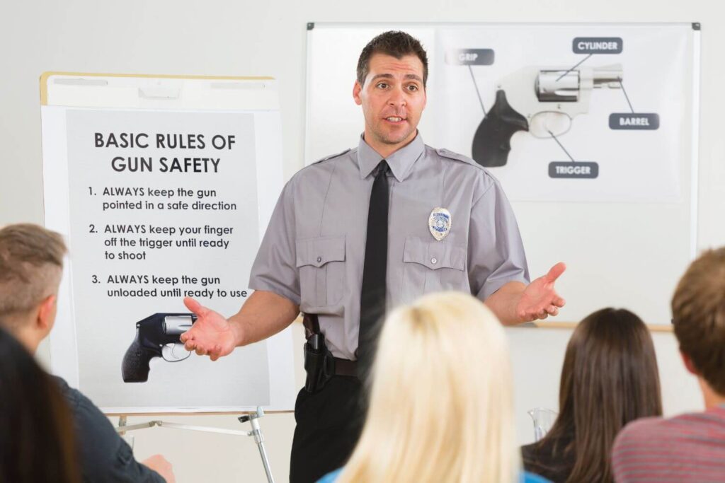 officer speaking to a group of people at a gun safety class - Premier Gun Parts And Accessories | JSD Supply officer speaking to a group of people at a gun safety class