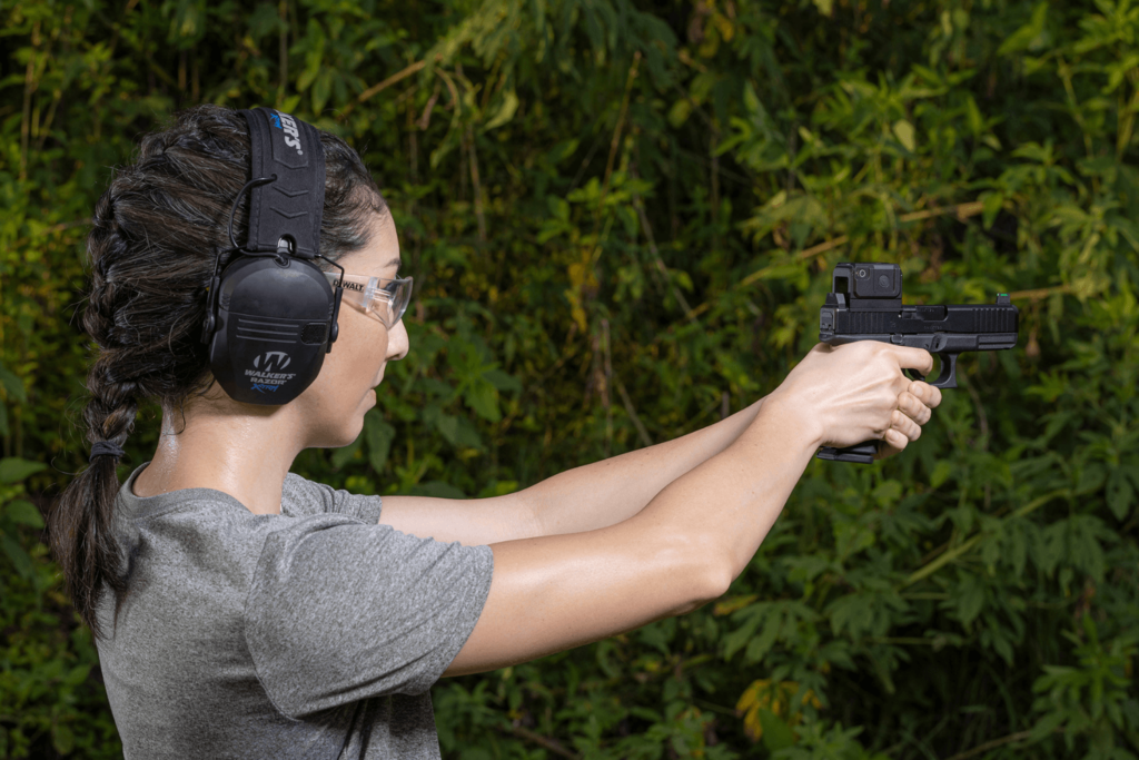 woman wearing protective ear and eyewear is aiming a pistol - Premier Gun Parts And Accessories | JSD Supply woman wearing protective ear and eyewear is aiming a pistol