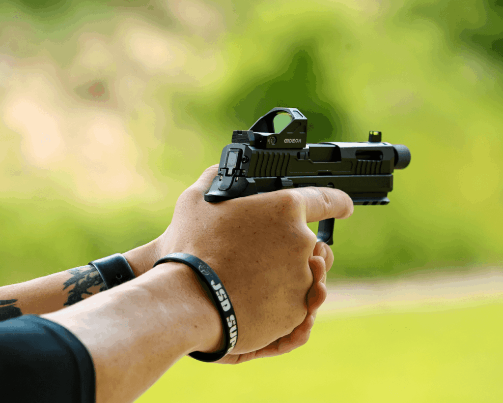 hands holding a pistol following proper safety rules